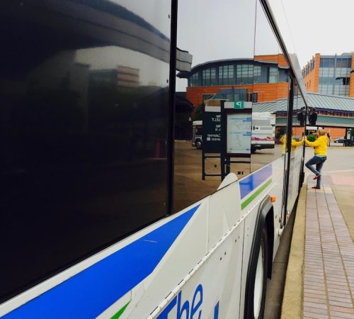 woman-getting-into-public-bus_1602129-48